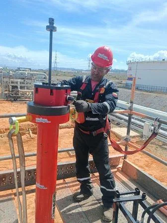 Operador ajustando equipo especializado de hot tapping en campo